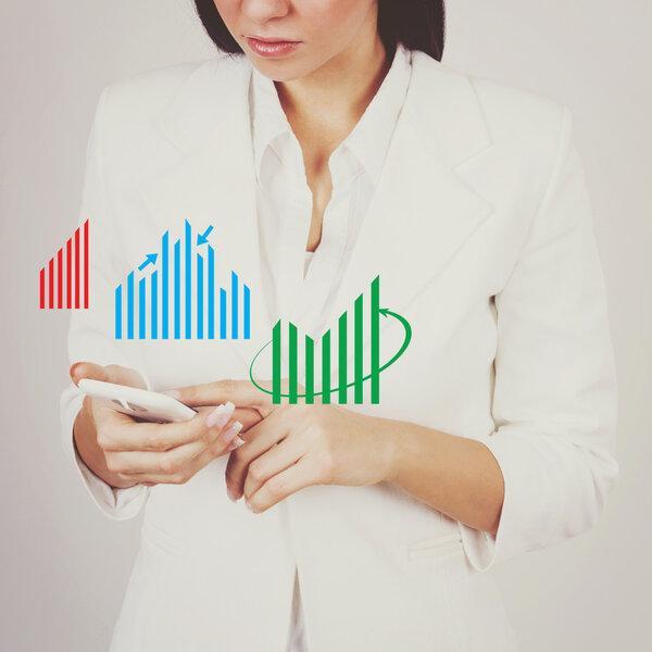 Businesswoman checking charts on smart phone